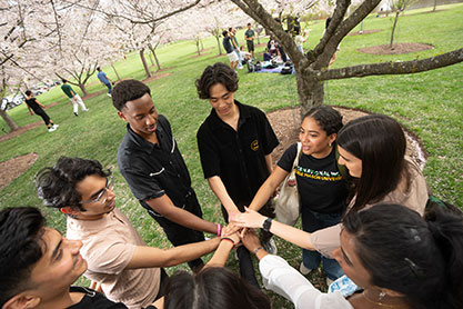 Students putting there hands together. Links to Beneficiary Designations Students putting there hands together. Links to Beneficiary Designations