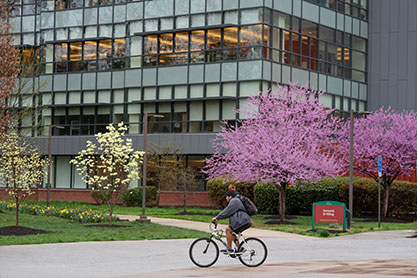 Student riding a bike. Links to Gifts of Real Estate Student riding a bike. Links to Gifts of Real Estate