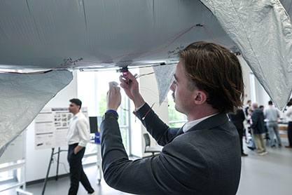 Student working on a model of a whale. Links to What to Give Student working on a model of a whale. Links to What to Give